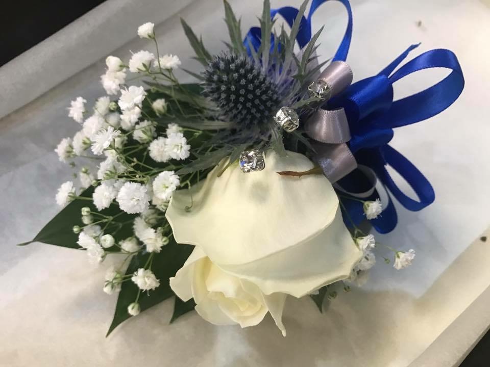 Wrist corsage with Rose and thistle Irene's Florist
